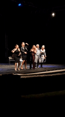 Five people perform on dark stage in Cetinje