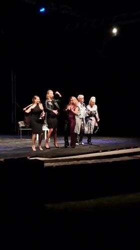 Five people perform on dark stage in Cetinje