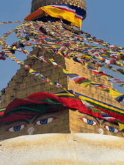 Golden Buddhist stupa photographed against blue sky in Kathmandu