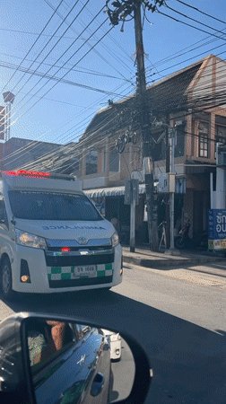 Ambulance, scooters spotted during morning traffic in Thai village