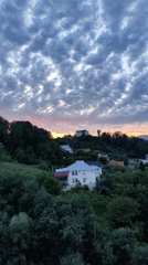Sochi hillside neighborhoods at sunset, clouds rolling in