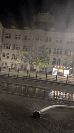 Fire hoses wet Poznań streets on a late summer night