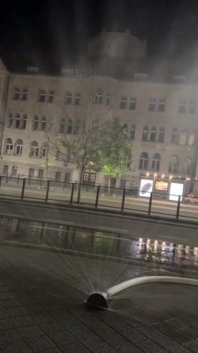 Fire hoses wet Poznań streets on a late summer night
