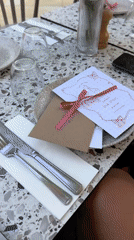 Pink baby shower table décor with hydrangeas and ribbon-tied menus