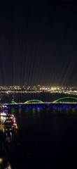 Vertical light beams illuminate Đà Nẵng skyline at night