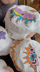 Custom-decorated bucket hats displayed by group in Markovskii, Russia
