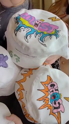 Custom-decorated bucket hats displayed by group in Markovskii, Russia