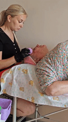 Woman receives facial massage treatment in Russian town