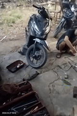 Man observed at outdoor motorcycle repair area