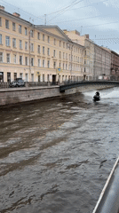 Jet ski riders speed through Saint Petersburg canal