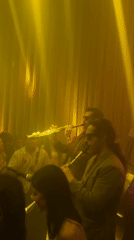Musicians perform with clarinets in dimly lit Madrid venue