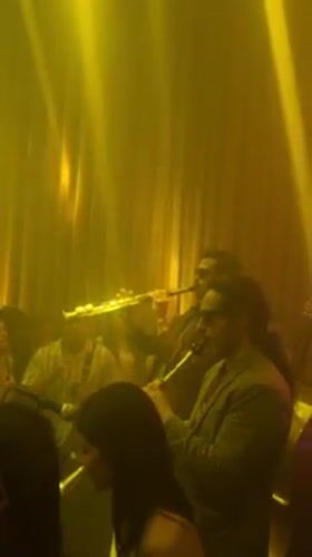 Musicians perform with clarinets in dimly lit Madrid venue