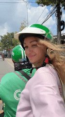 Woman rides motorcycle passenger in sunny Đồng Nai, Vietnam