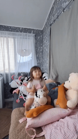Child plays with stuffed animals collection in Kempelevo bedroom