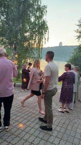 Riverside celebration with sparklers and birdhouse-covered tree, Krasnoyarsk