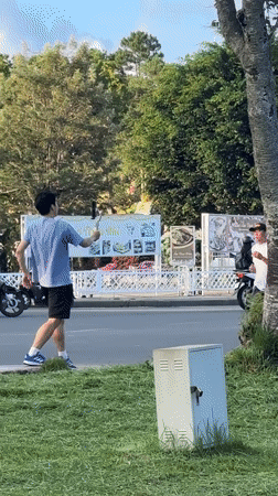 Man films jogger from roadside in Da Lat