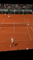 Tennis match observed on clay court in Nha Trang