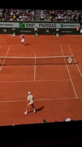Tennis match observed on clay court in Nha Trang