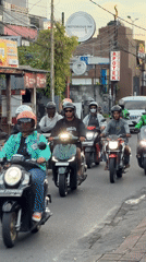 Motorcycle group rides through North Kuta, Bali streets