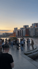 Evening social gathering on Yekaterinburg waterfront draws dancers, walkers