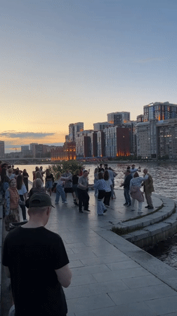 Evening social gathering on Yekaterinburg waterfront draws dancers, walkers
