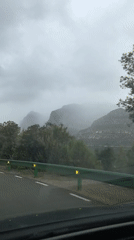 Car travels road near Esparreguera under overcast skies
