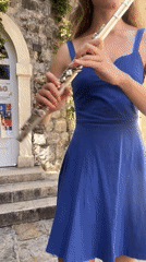 Street musician performs flute on historic Budva walkway