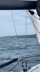 Boat sails past lighthouse in choppy Vladivostok waters
