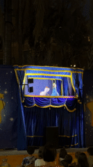 Nighttime puppet show with Elsa-like characters in Ospedaletti