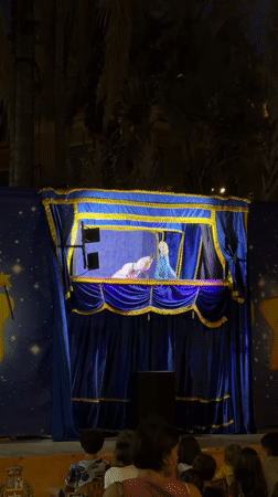 Nighttime puppet show with Elsa-like characters in Ospedaletti