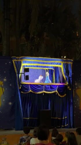 Nighttime puppet show with Elsa-like characters in Ospedaletti