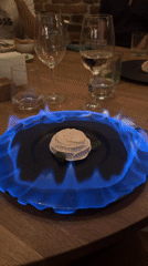 Diner enjoys flambéed dessert and wine in Sofia restaurant
