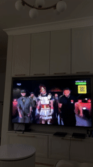 Person watches boxing match and TV shows at home