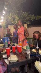 Young women celebrate at nighttime outdoor party in Nigeria