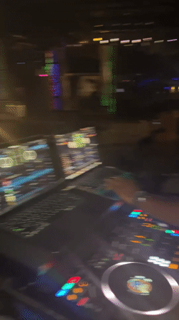 Late-night DJ set and crowd at a Howayi venue