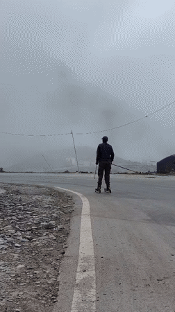 Misty Buddhist hillside in Burwa, prayer flags and roller skis