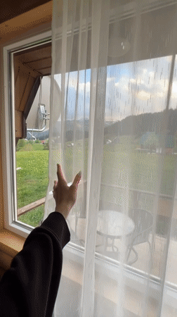 Curtains opened to reveal mountain valley view from Montenegro patio