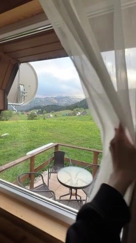 Curtains opened to reveal mountain valley view from Montenegro patio