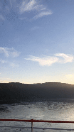 Boat passenger films calm waters near Divnogorsk, Russia