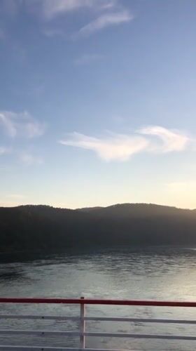 Boat passenger films calm waters near Divnogorsk, Russia
