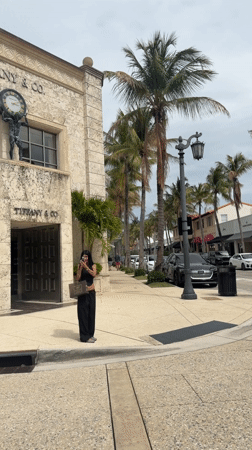 Woman takes photo outside Tiffany store in Palm Beach