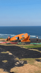 Paragliding operations documented on Indonesian clifftop morning session