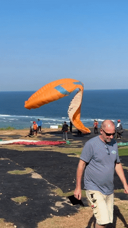Paragliding operations documented on Indonesian clifftop morning session