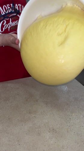 Baker pours yellow dough in Bulgarian kitchen