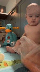 Mother and baby playtime captured in Moscow home