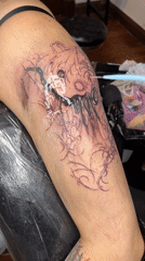 Tattoo artist works on dark cartoon design in Buenos Aires