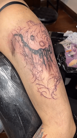 Tattoo artist works on dark cartoon design in Buenos Aires
