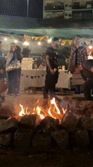 Nighttime bonfire gathering draws crowds at Buenos Aires market