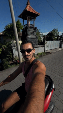 Man rides red scooter on North Kuta road