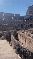 Tourists visit Rome's Colosseum on sunny afternoon